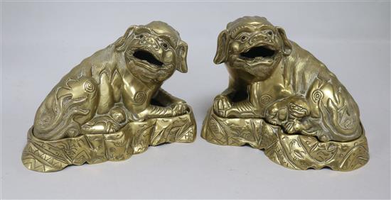 A pair of Chinese bronze lion-dogs on stands, early 20th century
